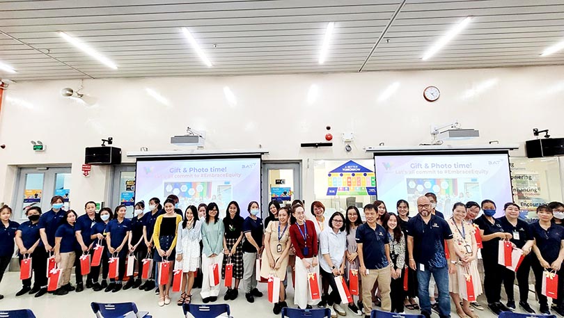Members eagerly receive gifts and capture memorable moments together