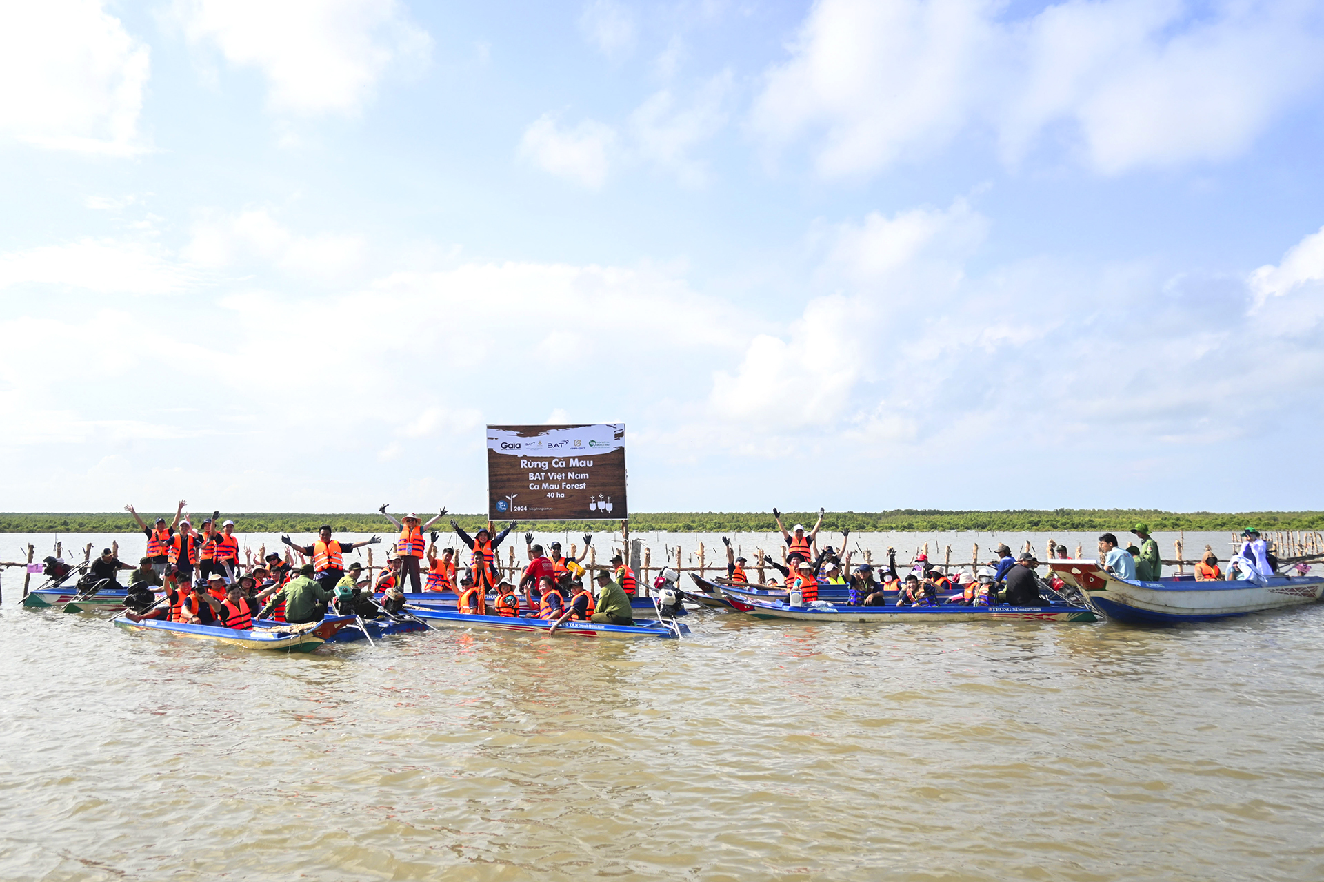 Team assembled in boats ready to plan mangrove
